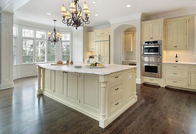 close-up of hand scraping laminate floor in Canadian Lakes